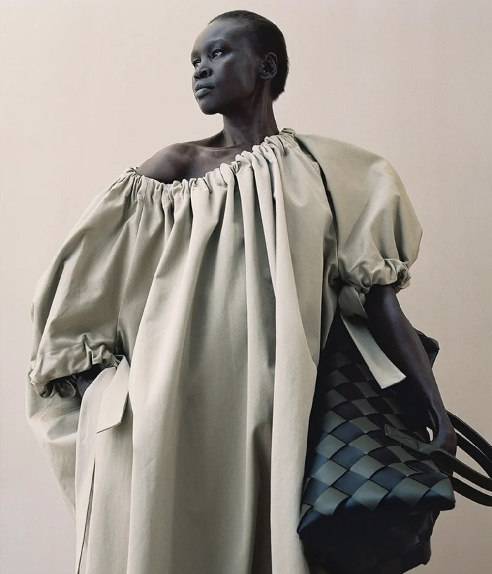 Model in a voluminous pale garment looking to the side, photographed by Campbell Addy for WSJ Magazine