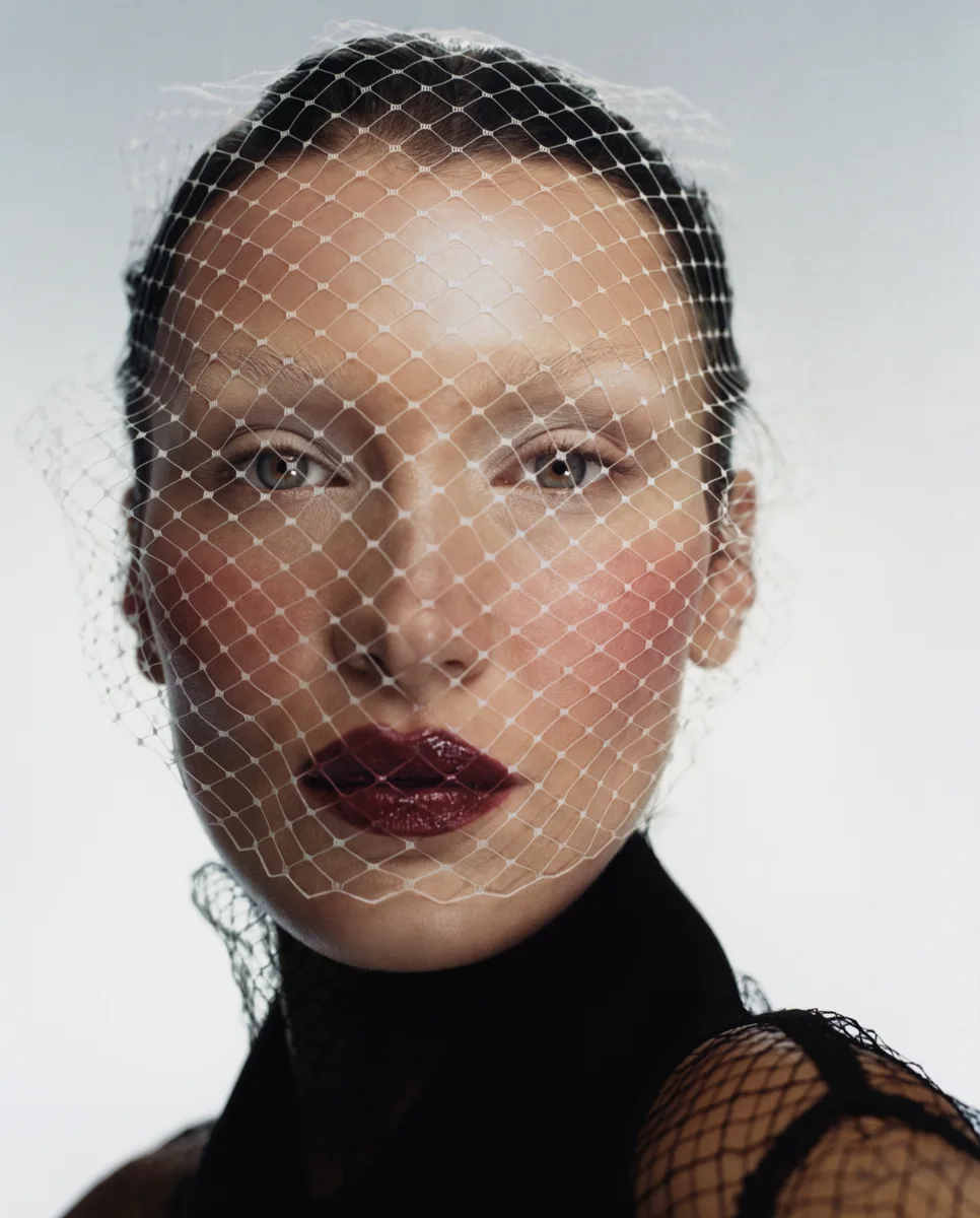 Close beauty portrait through a fine mesh veil, photographed by Harley Weir