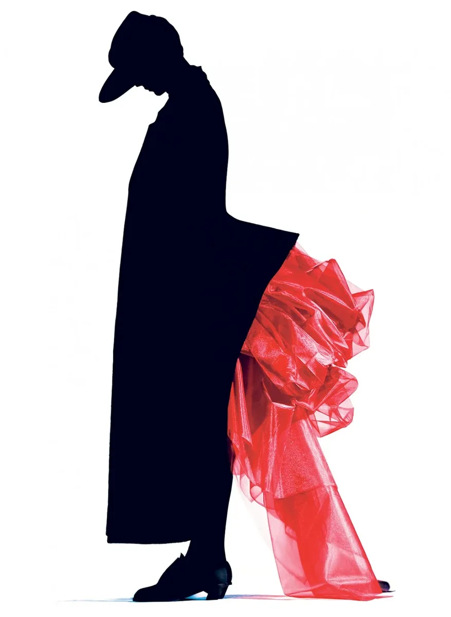 Black silhouette with a sculptural red bustle against white, photographed by Nick Knight for Yohji Yamamoto in 1986